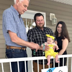 Executive Director, Greg, gives key to Habitat Family