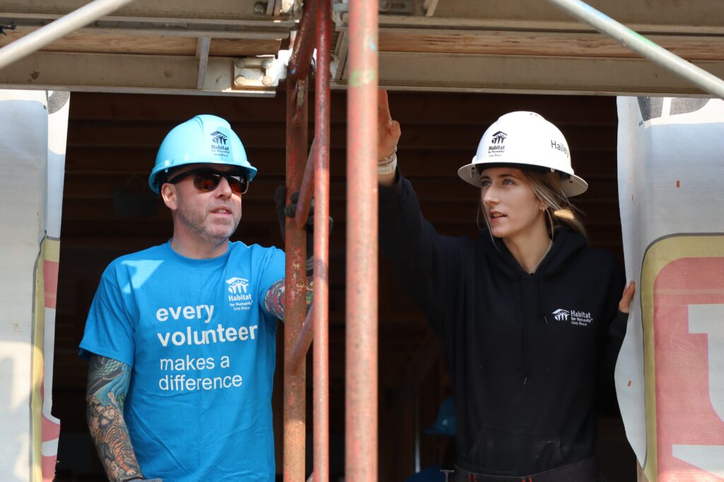 Volunteer and staff work together at the Build site.